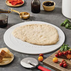 white pizza stone with dough