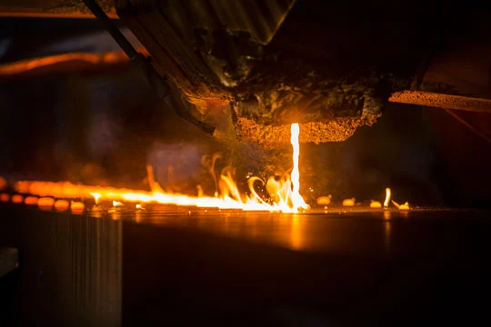 pouring molten cast iron into molds