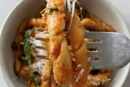 tomato sauce covered pasta with a unique spiral shape