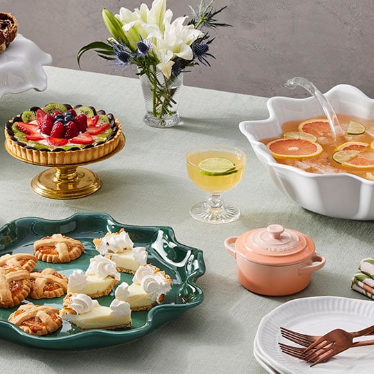 a festive table with punch and cakes