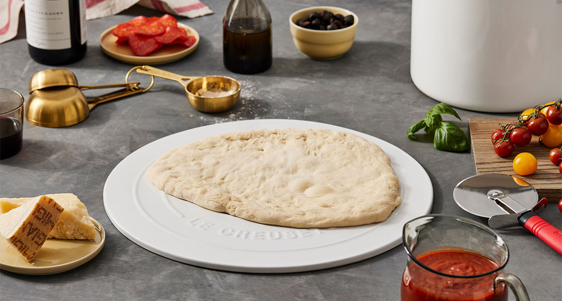 pizza dough on a counter with ingredients