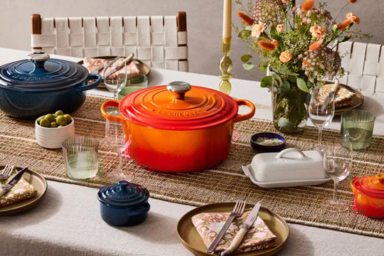 orange and navy cookware on a table
