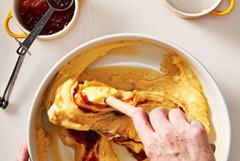 mixing jam into the batter