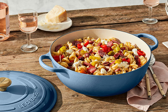 summery pasta salad in a shallow dutch oven