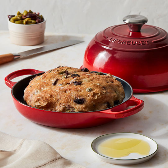 fresh baked bread in a cerise red bread oven