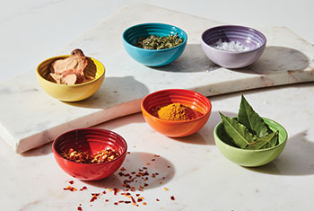 tiny bowls filled with herbs and spices