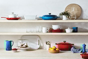 red, white and blue cookware on shelves