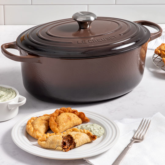 empenadas next to a ganache brown dutch oven