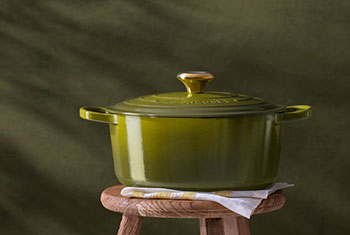 a person works with dough in a Le Creuset bread oven