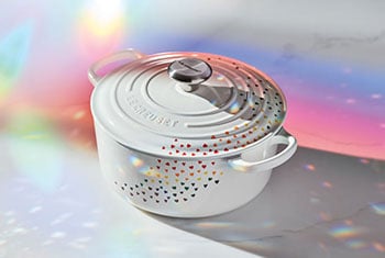 white ducth oven with a rainbow of tiny hearts