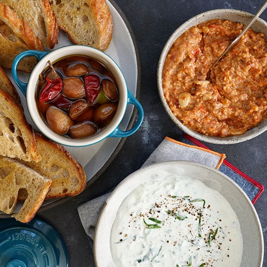 marinated olives, creamy yogurt dip and a spiced dip served with baguette slices