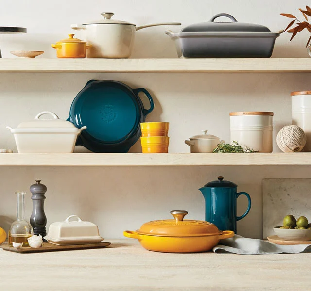 oyster gray on shelves featuring an array of vibrant Le Creuset colors