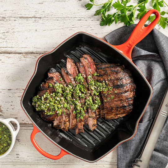 steak topped with herb sauce
