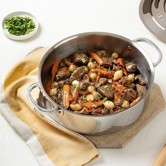 beef stew in a shallow stainless steel pot