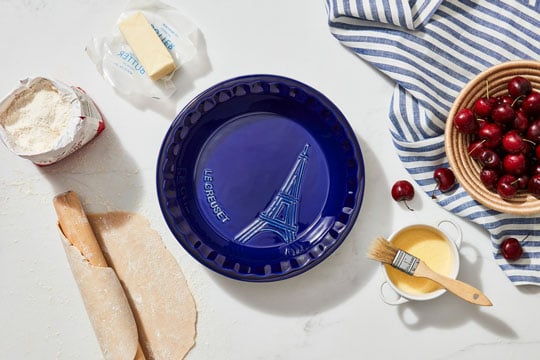 indigo blue pie dish with eiffel tower embossed to the right of the center