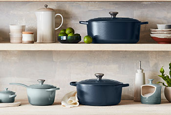 shades of blue and off white cookware arranged on shelves