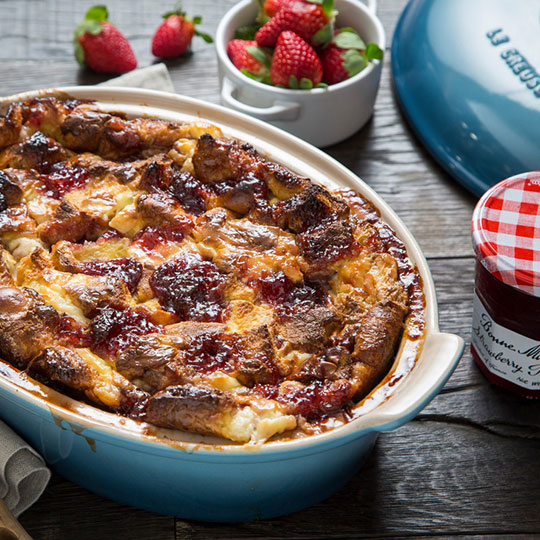 golden brown bread pudding with berries