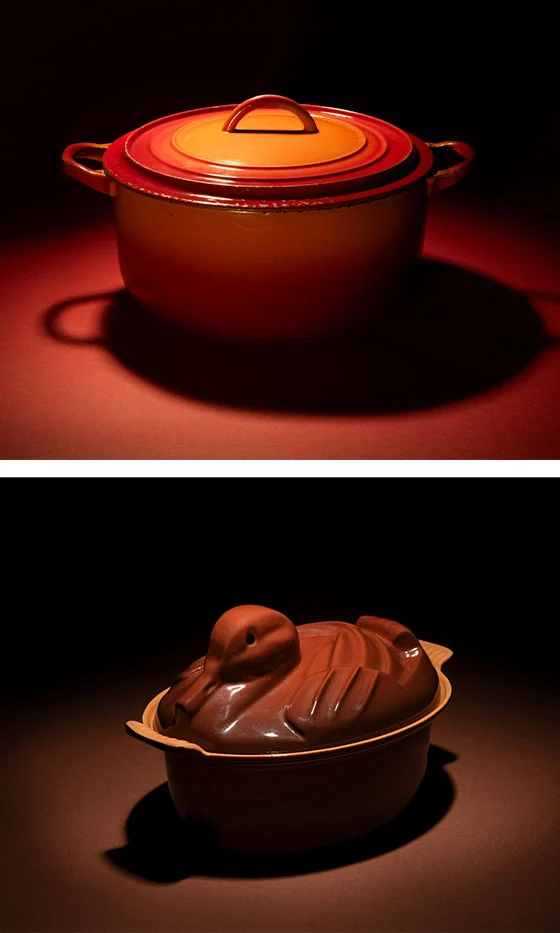 two historical pieces from Le Creuset including one shaped like a duck