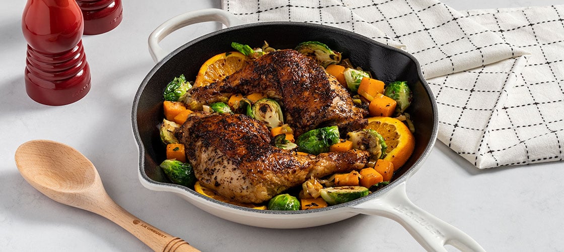 blackened chicken in a white skillet