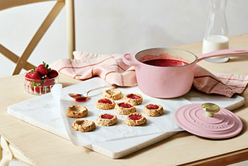 cookies being made with a pink saucepan
