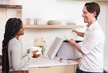 a couple cooking with Le Creuset in their kitchen