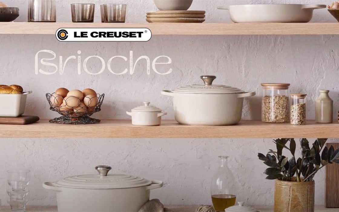 assorted brioche cookware on kitchen shelves with a Brioche logo and a Le Creuset logo over the image