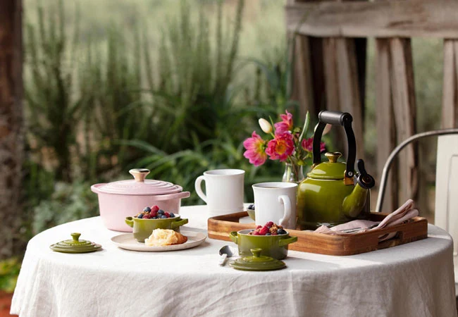 table set with pink and olive green items