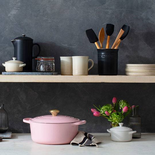 pink and black cookware on shelves