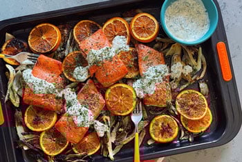 salmon and orange slices on a sheet pan