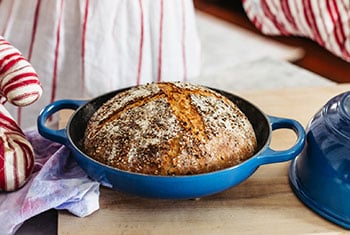 fresh baked boule of bread in a bread oven