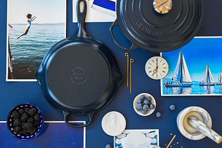 matte navy cookware shot from above surrounded by navy colored items