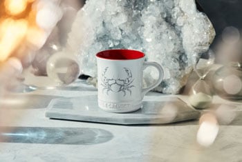 white mug with red interior and a crab design on side