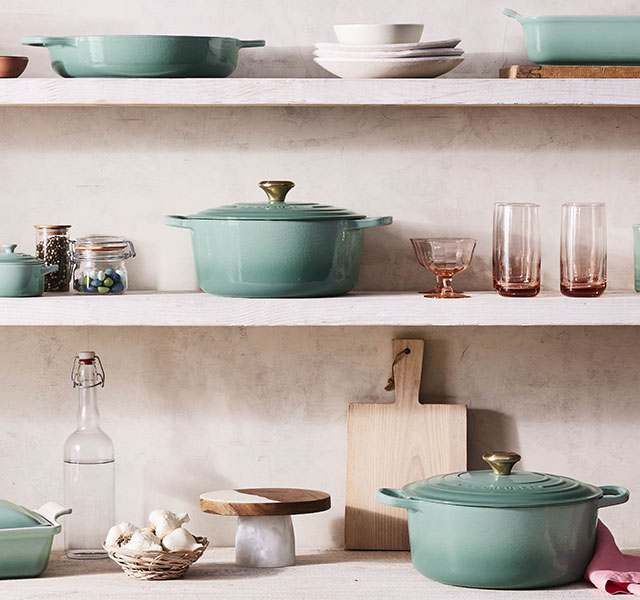 sage cookware on shelves
