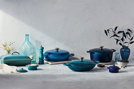 assorted shades of blue le creuset cookware