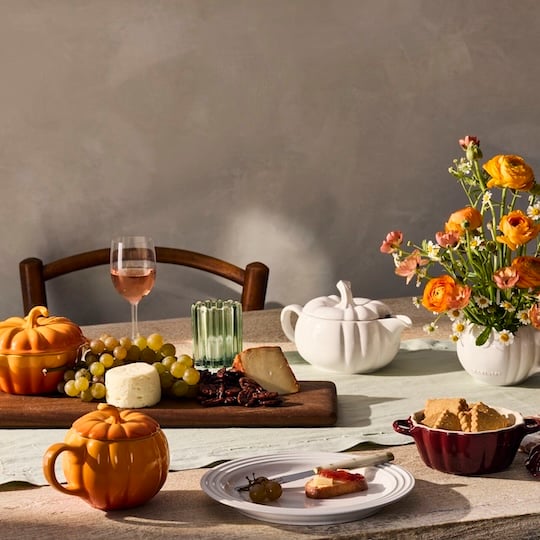 table setting featuring multiple pumpkin shaped pieces