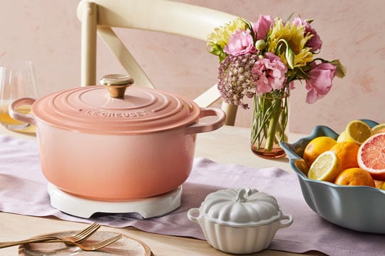 softer colors dominate a tablescape anchored by a peach Dutch oven