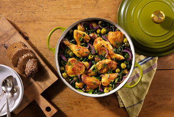 chicken stew in an olive green dutch oven