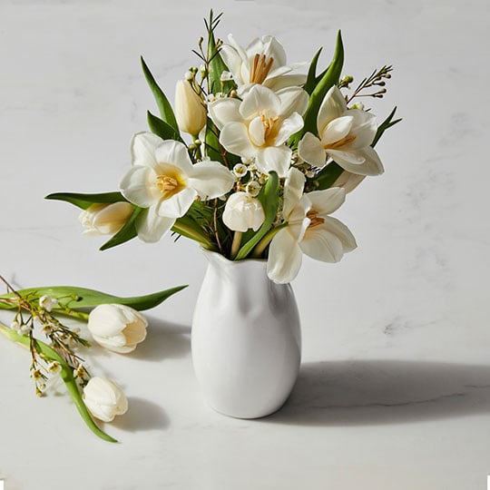 white vase with flowers