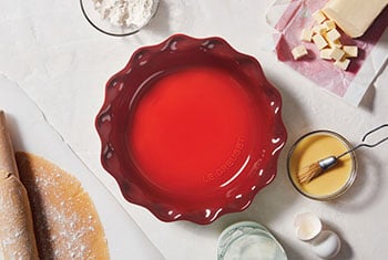 red pie dish with fluted rim