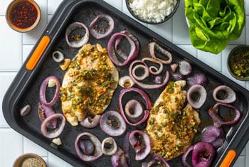 veggies and chicken on a non-stick sheet pan