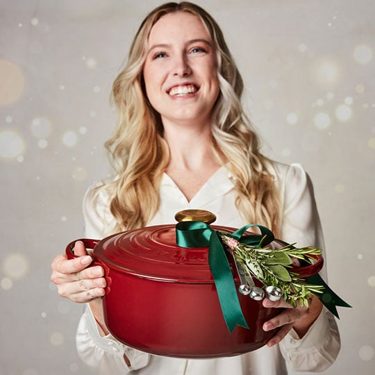 smiling woman holds dutch oven in rhone