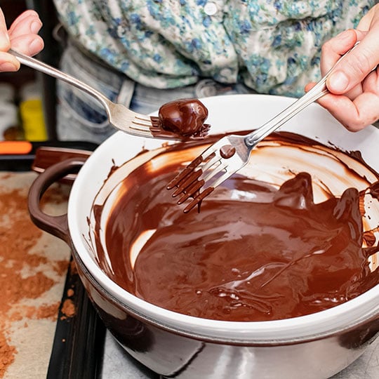 dipping truffle in chocolate