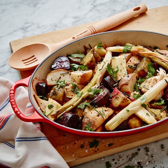 roasted vegetables in an oval cast iron baking dish