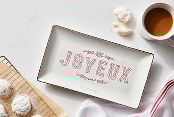 rectangular tray with the word joyeux in shiny silver and red on the top