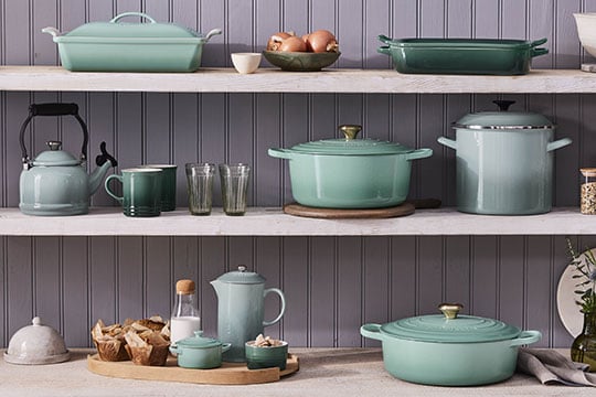 shades of green cookware on a shelf