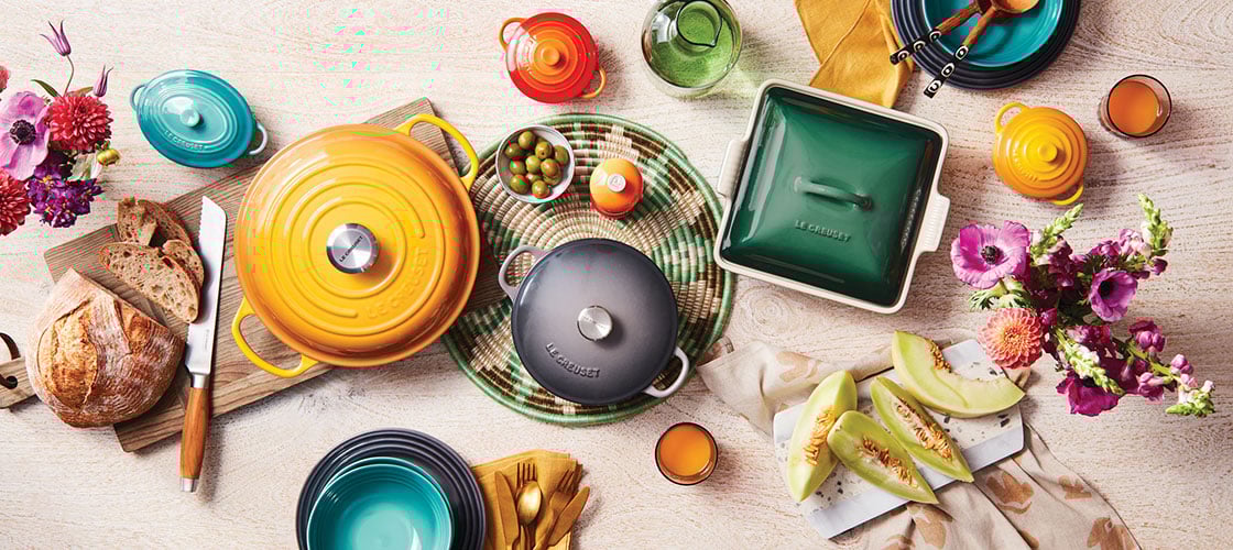 assorted colorful cookware spread on a table