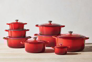 stacks of red dutch ovens