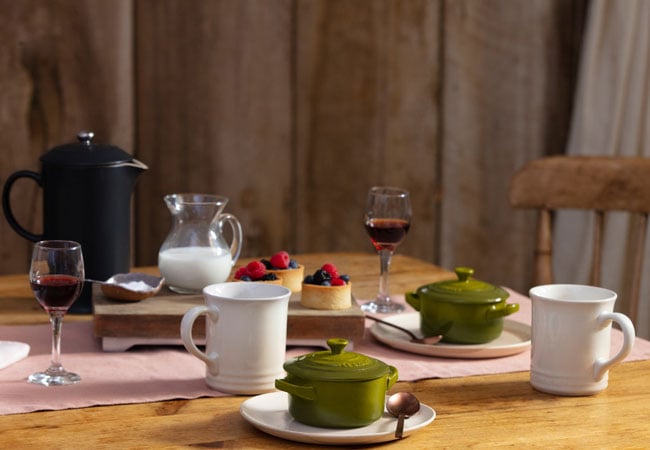 table set with olive green, white and black items