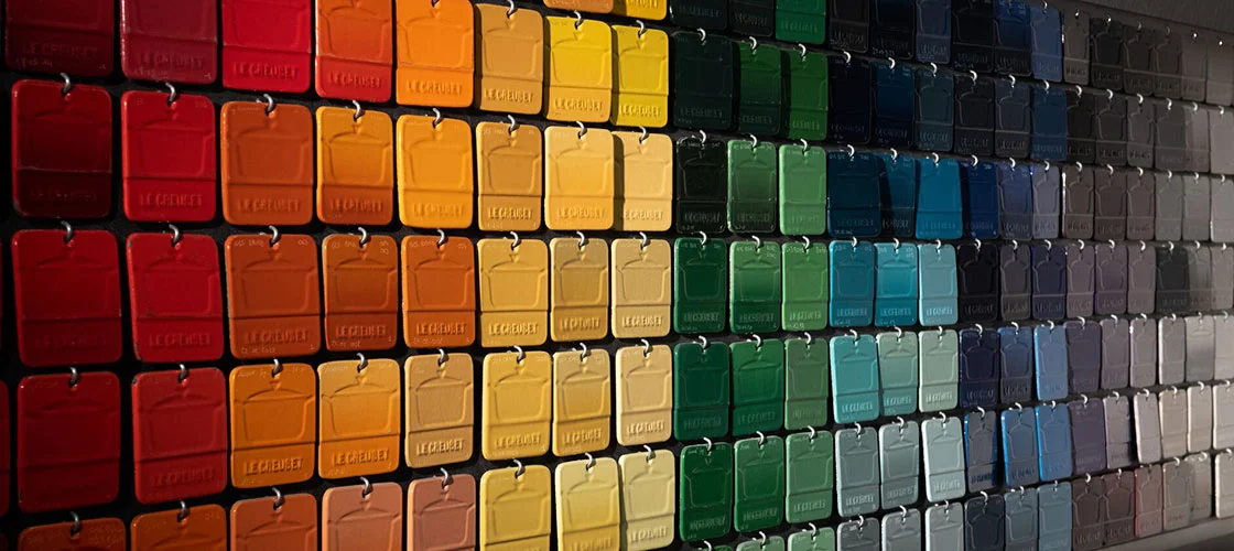 a rainbow of color chips at the Le Creuset factory