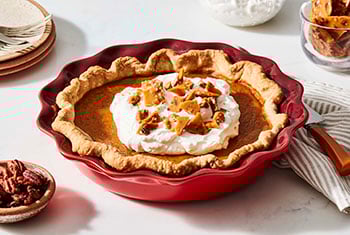 sweet potato pie in a red ruffled pie dish